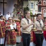 Roveři se svícny v průvodu před schránkou s relikvií patrona české země
